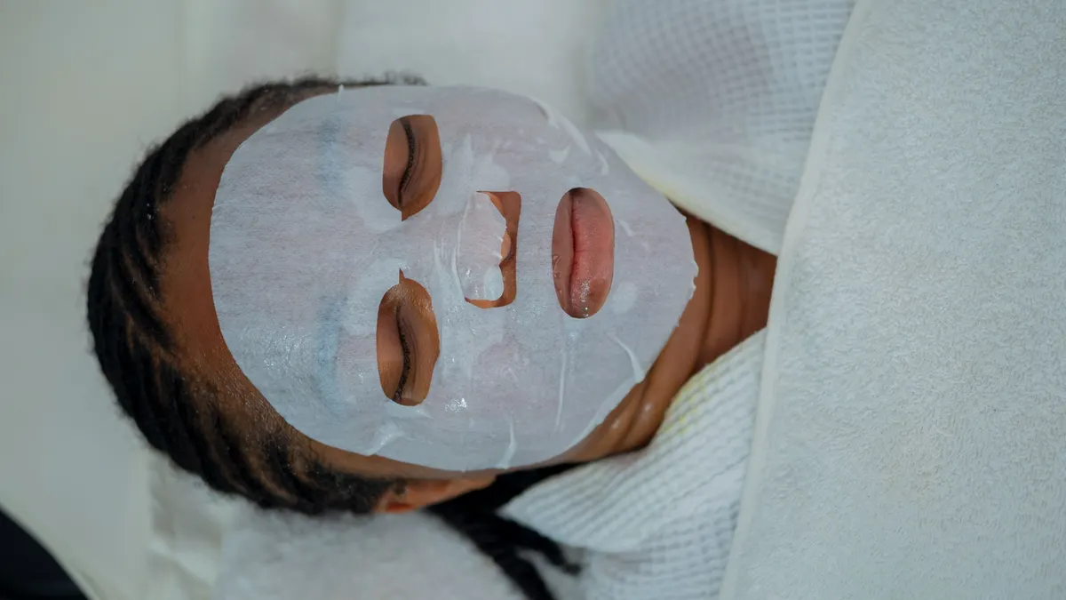 Person lying down wearing a sheet face mask
